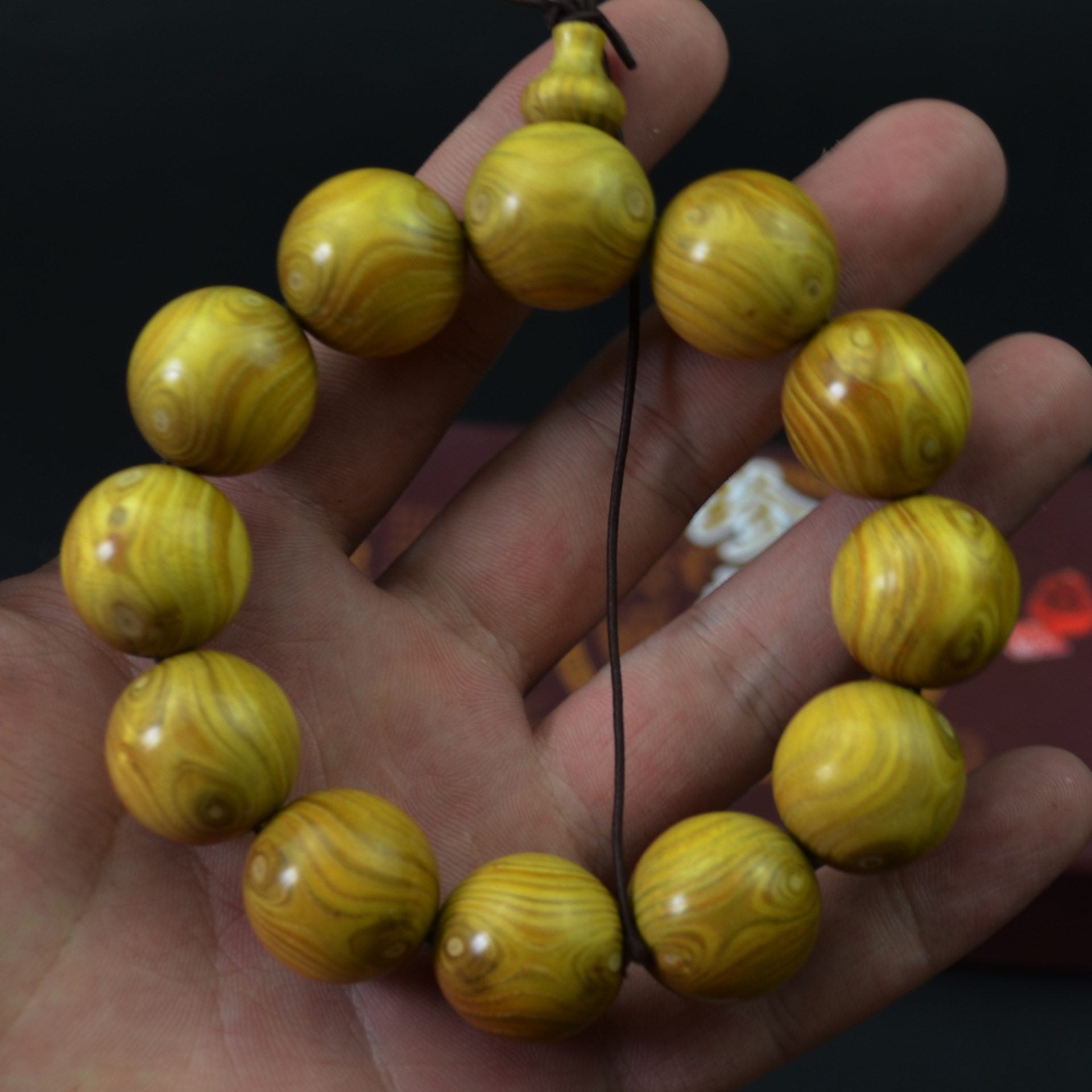 厂家批发海南黄金柚木鬼脸对眼20x12粒手串手链颗颗有