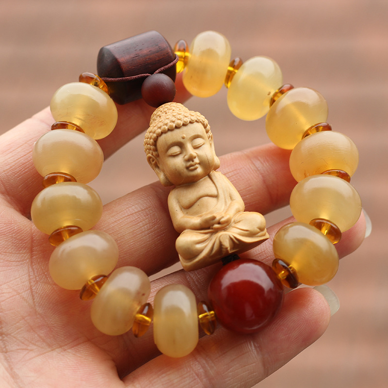 品名天然西藏羊角单圈黄杨木释迦牟尼款手串主材质