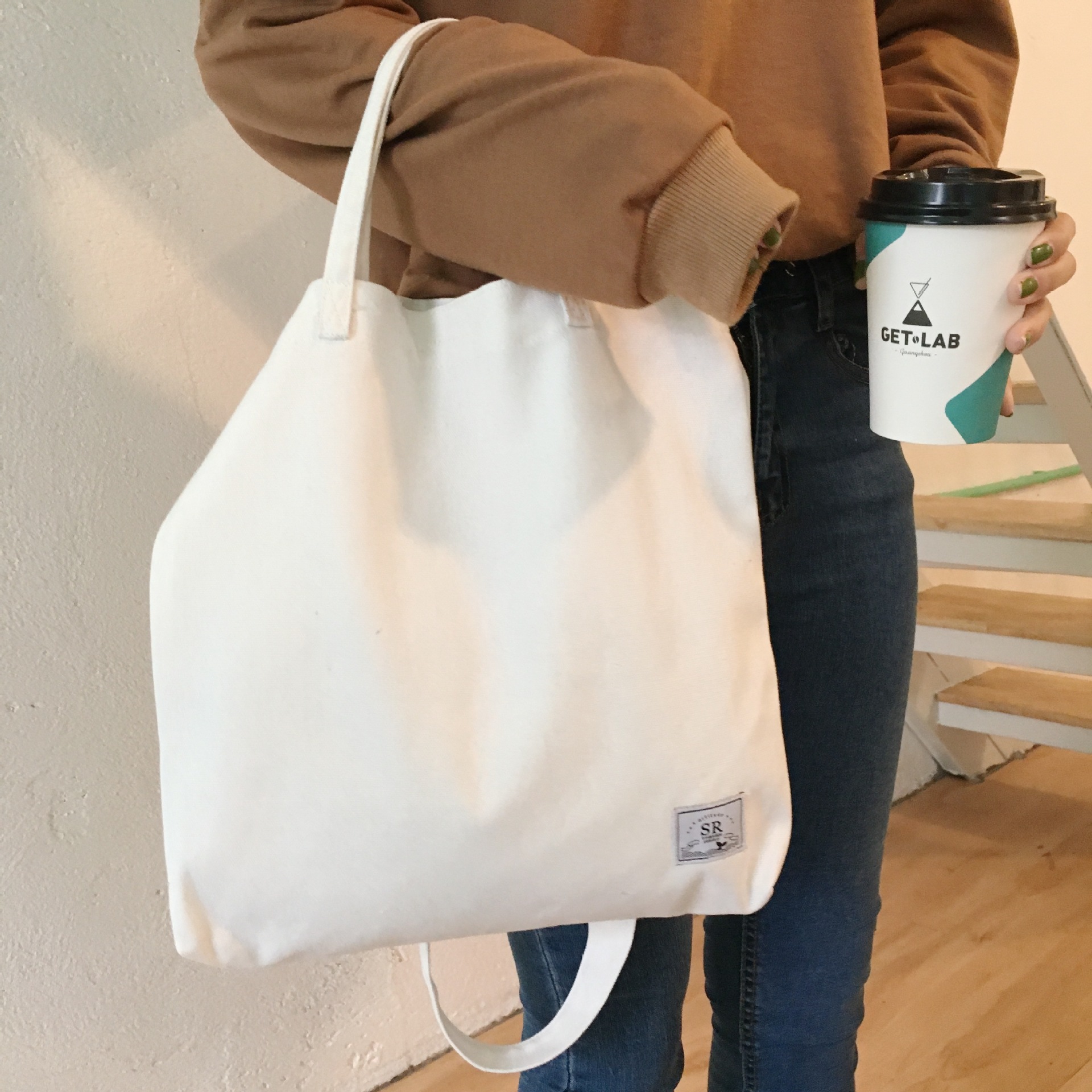 包邮纯色文艺百搭贴标斜挎手提三带两用帆布包环保购物袋学生书包