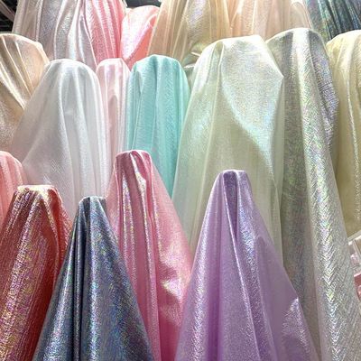 新款涤纶幻彩面料服装头饰发饰舞台装饰玩具布料婚庆亮纱七彩纱布