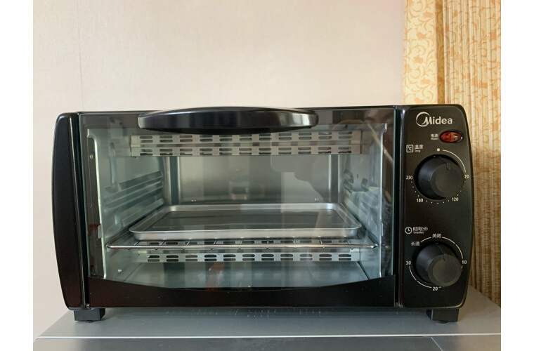 美的t1-108b家用多功能迷你黑色小烤箱10l机械式烘培上下一体控温