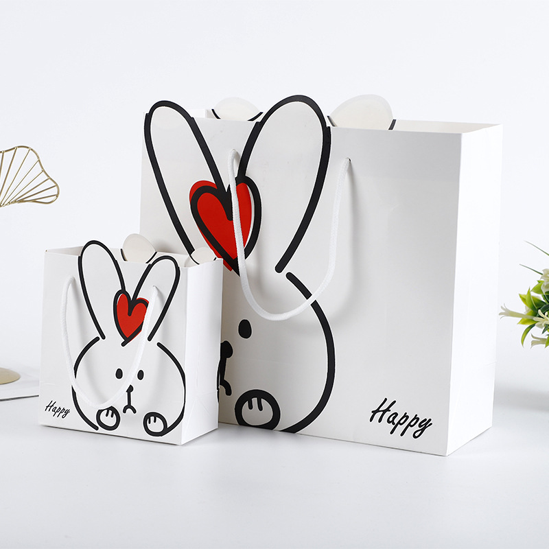 厂家直销礼品纸袋可爱卡通兔子异形手提白卡纸购物袋广告手提袋