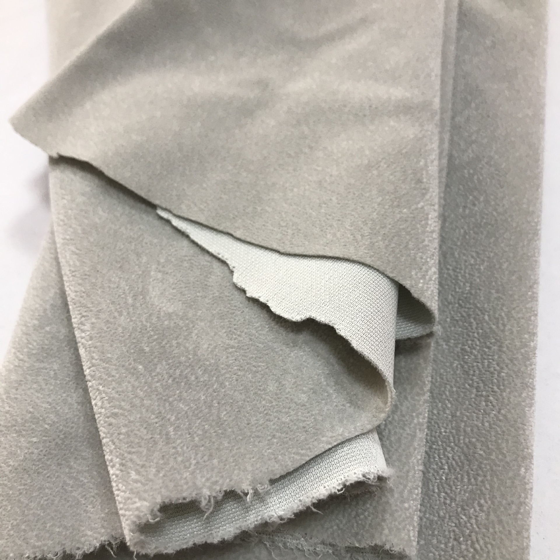 厂家直供灰色针织底植绒布单面绒毛绒布料全涤背景布珠粒绒布