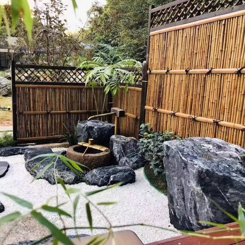 日式枯山水黑山石水溪驳岸野山石假山石景墙草坪摆设景观石厂家