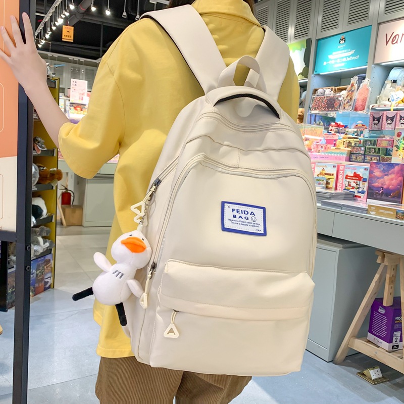 2023 New Middle School Student Schoolbag Female Junior High School Student Burden Alleviation Backpack High School Student College Style Pure Color All-Matching Backpack