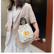 简约笑脸印花水桶包包女2024新款日韩学生可爱帆布单肩包手提包
