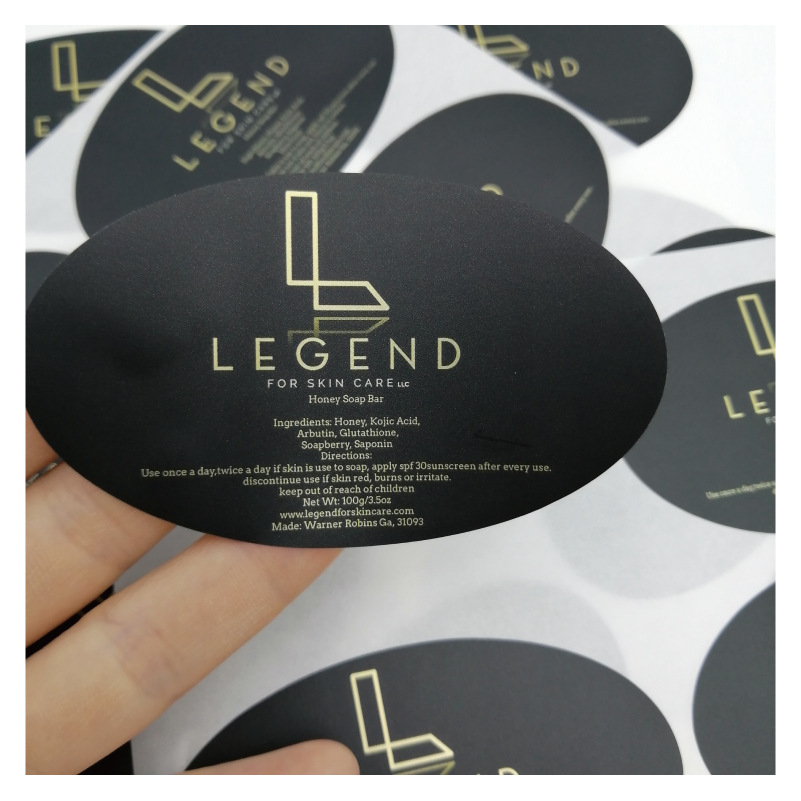 椭圆形哑膜不干胶贴标 黑底印金色字低奢标 护肤品黑色标签贴纸