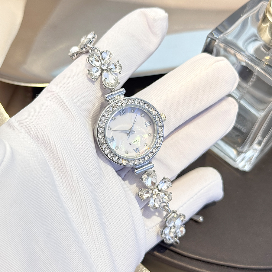 New fashionable women's bracelet/watch with floral teardrop design, diamond embellishments, mother-of-pearl, and quartz clasp. Adjustable.