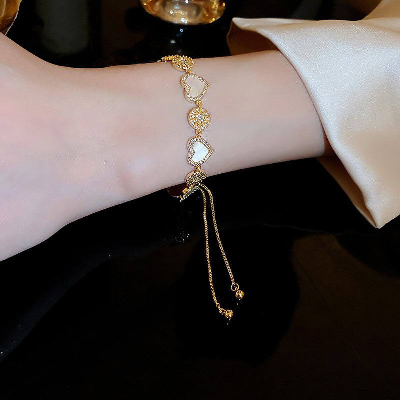 Adjustable gold-plated zircon heart and flower bracelet, a popular and niche luxury design for women.