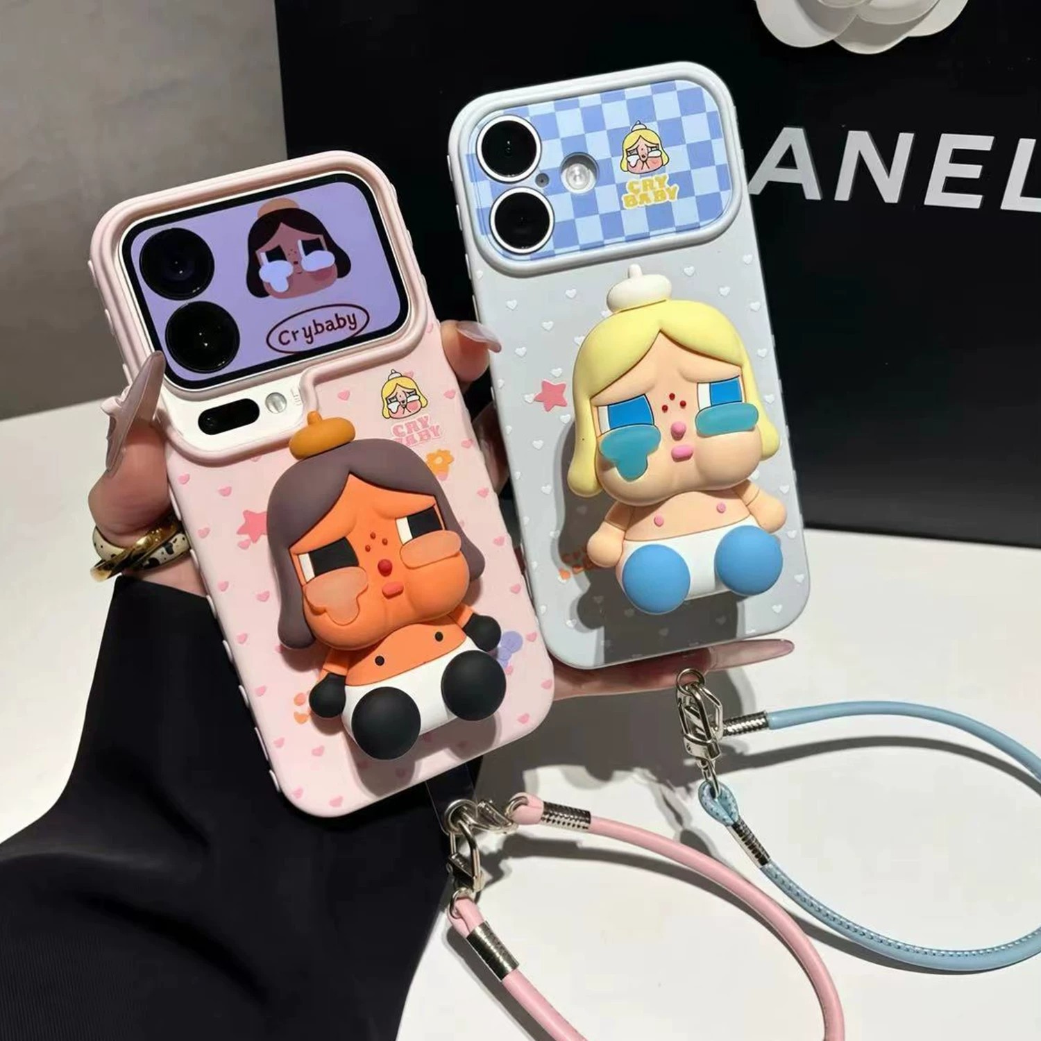 A black, heart-filled, crying baby case suitable for iPhone 16, instantly transforming it into a shockproof iPhone 17 case.