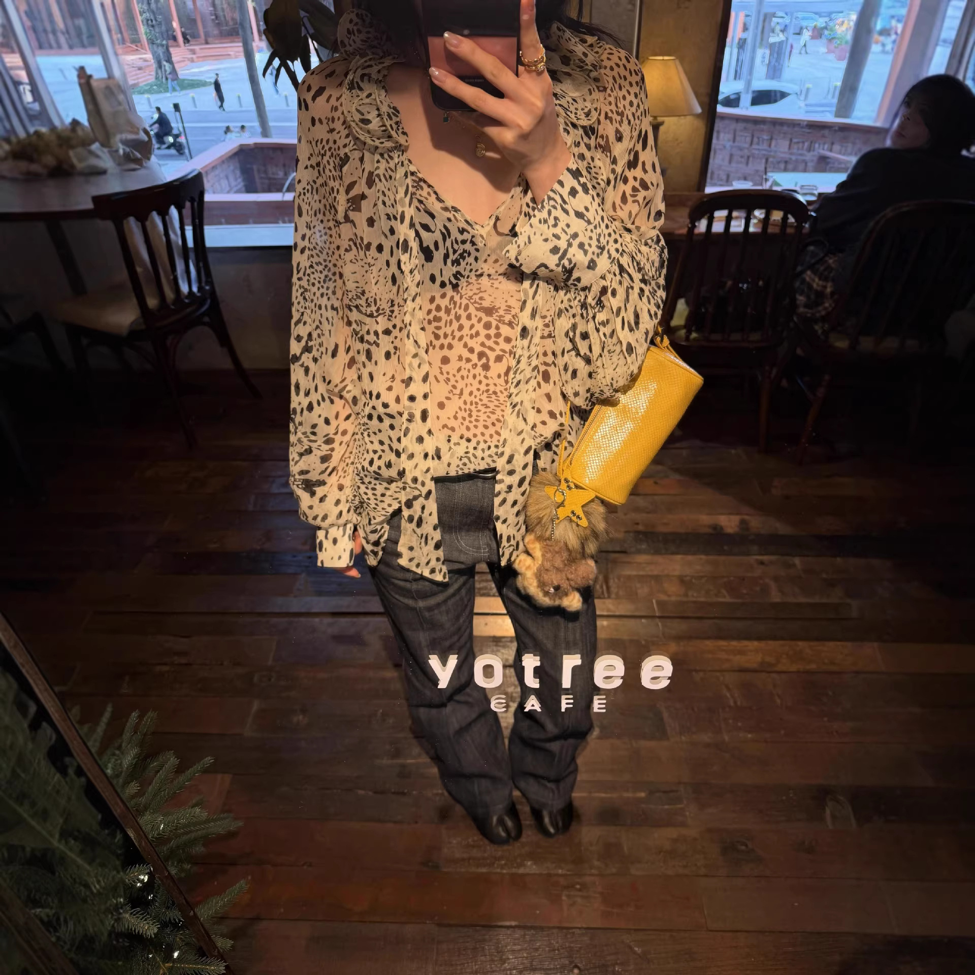 Correct version! A slightly sheer, apricot-colored shirt with an irregular leopard print, multi-layered, three-dimensional ruffled hem and tie detail.