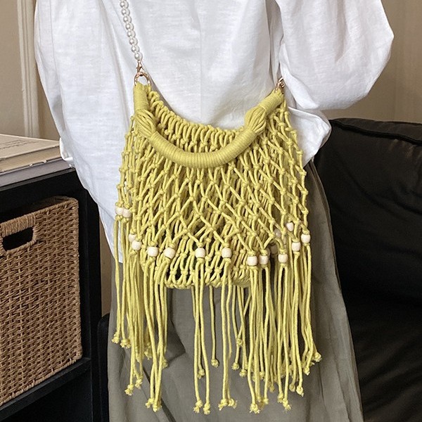Bohemian ethnic style tassel woven bag for women, new summer 2026, hollowed-out beach vacation shoulder/crossbody bag.