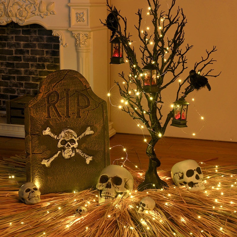 Halloween decorations, including a large ghost tree ornament, a pile of scary skulls at the entrance of bars and shops, and other atmospheric scene decorations.