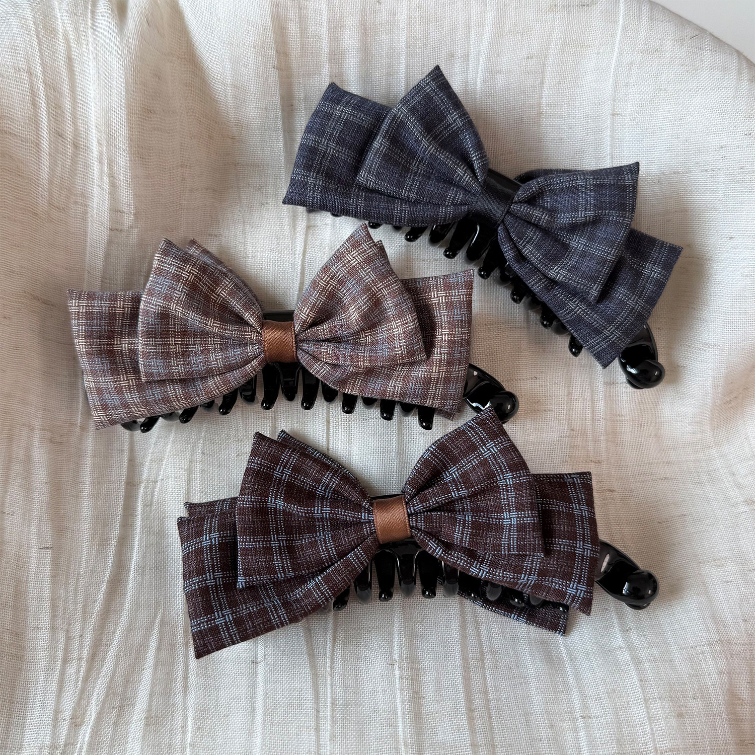 Korean-style plaid bow hair clip, a chic and lightweight accessory for women, perfect for creating a neat bun at the back of the head, suitable for autumn and winter, and available in dark colors