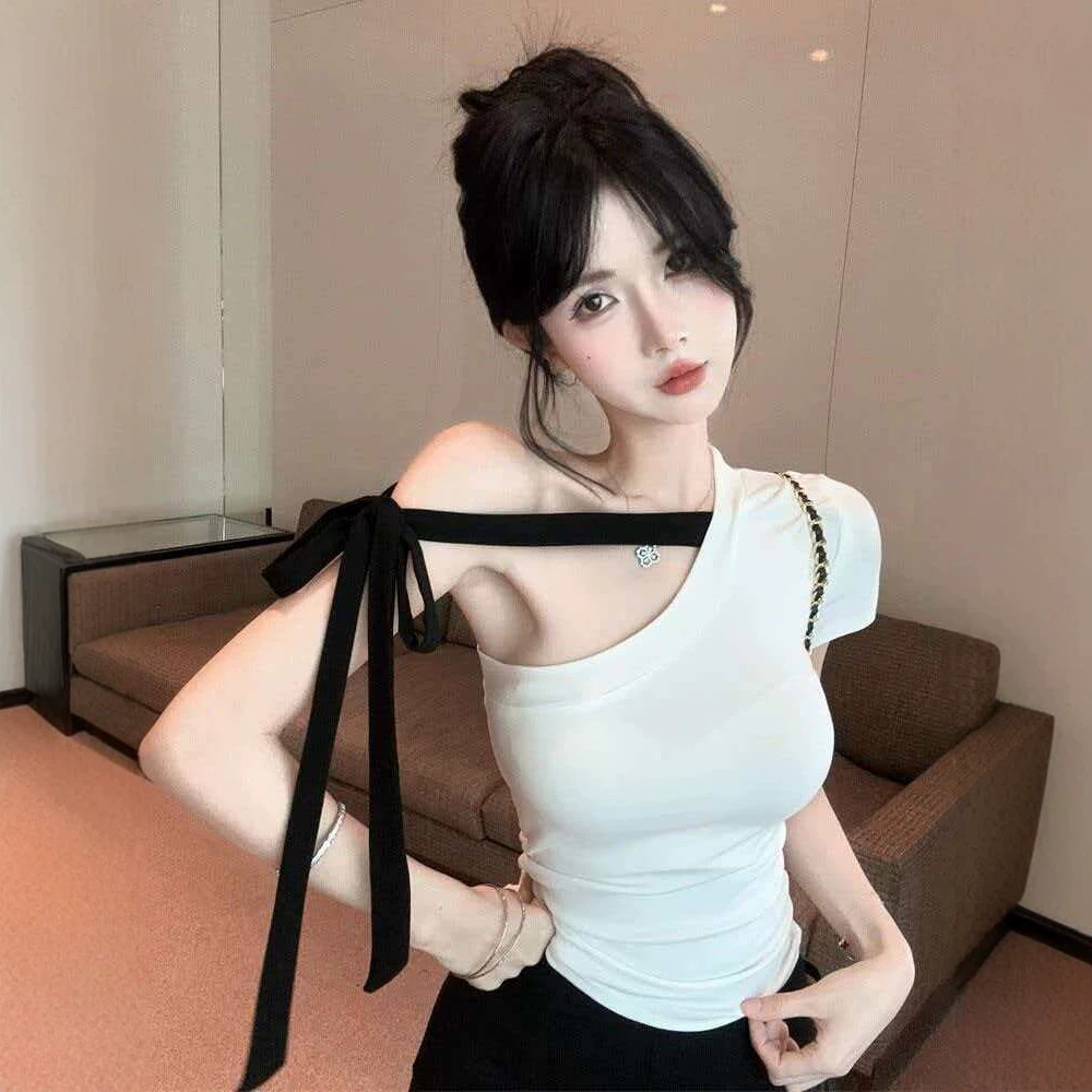 Chanel-inspired off-shoulder short-sleeved t-shirt with a slanted neckline and tie detail, perfect for summer. A unique and stylish top with flowing ribbons.