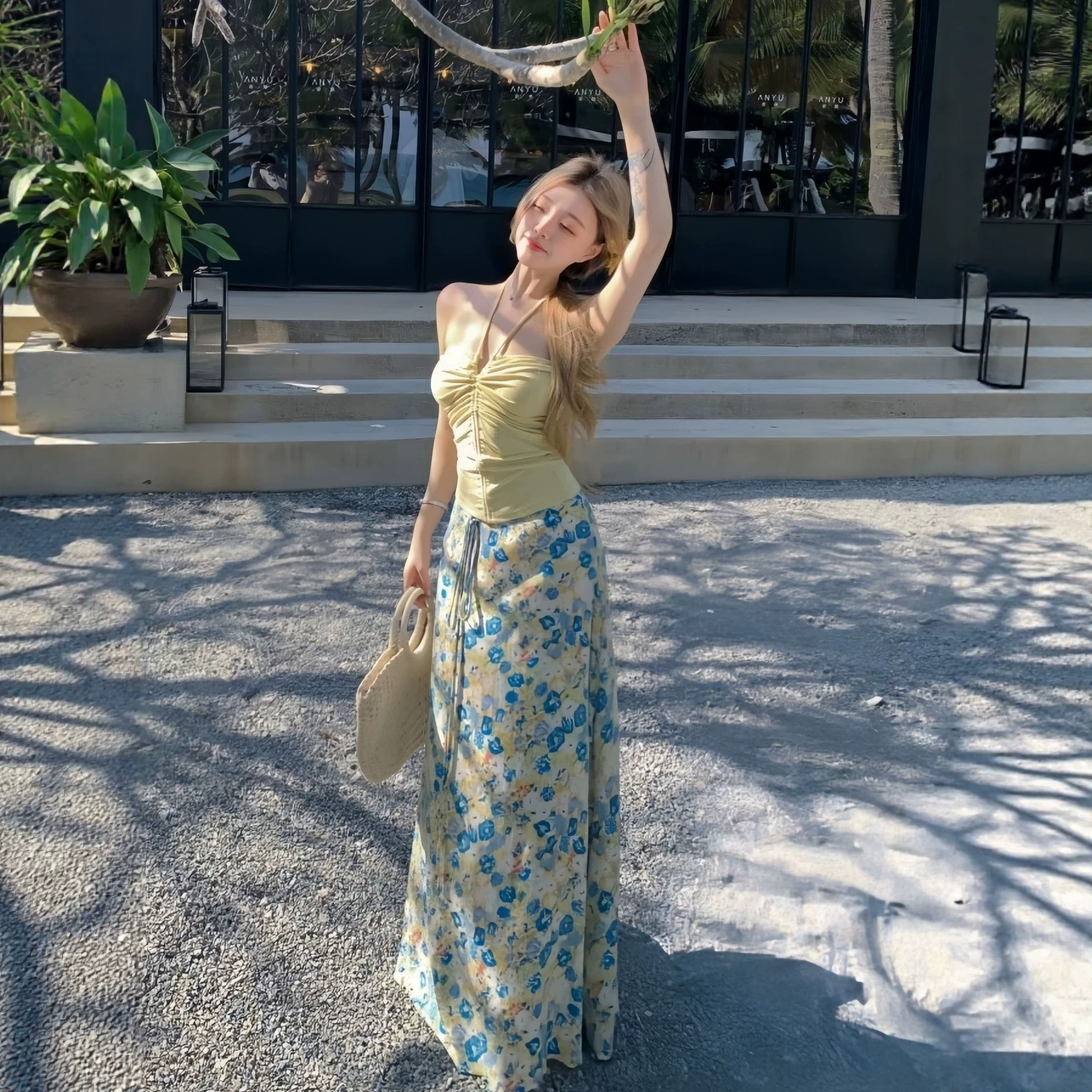 Outfits for Women for Seaside Vacations in Thailand: Yellow Halter Neck Tank Top Paired with Floral Print Skirt Two-Piece Set