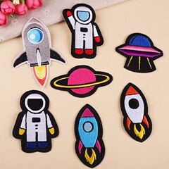 Embroidered patch with computerized stitching, a fine DIY craft featuring a planet, astronaut, and rocket for clothing decoration.
