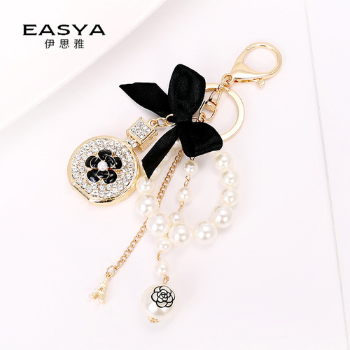 Korean version of the new creative small gift pendant perfume bottle bow shape alloy keychain pearl pendant wholesale