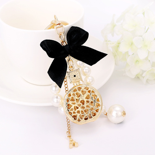 Korean version of the new creative small gift pendant perfume bottle bow shape alloy keychain pearl pendant wholesale