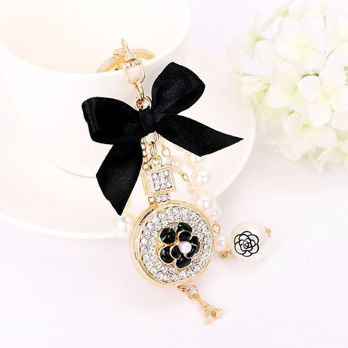 Korean version of the new creative small gift pendant perfume bottle bow shape alloy keychain pearl pendant wholesale