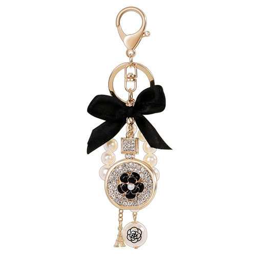 Korean version of the new creative small gift pendant perfume bottle bow shape alloy keychain pearl pendant wholesale