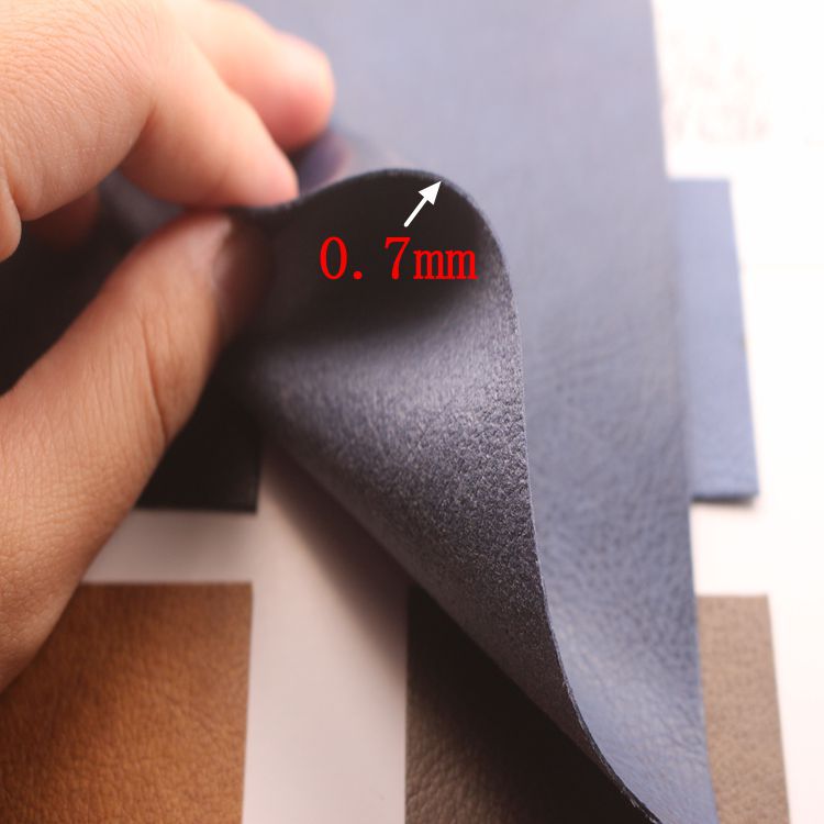 厂家现货直销0.7mm水刺底压变荔枝纹PU革包装盒手机套各类装饰革