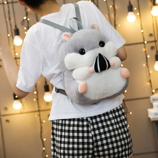 Gray hamster holding melon seeds (backpack)