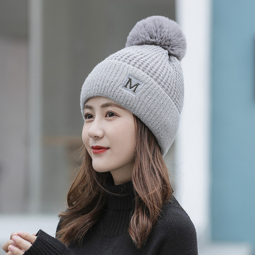 Japanese new style M letter hat fashionable knitted hat for women Korean version winter plus velvet warm hat fur ball woolen hat