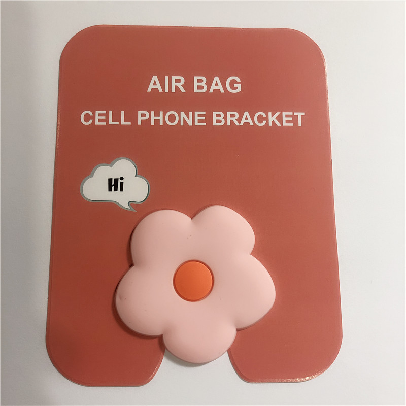 En stock al por mayor TikTok Cartoon creativo soporte de teléfono móvil puede soportar airbag soporte de teléfono móvil soporte de escritorio