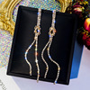 Long universal asymmetrical earrings from pearl with tassels, bright catchy style