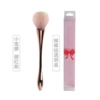 Wineglass contains rose, golden face blush, brush with bow, pack PVC