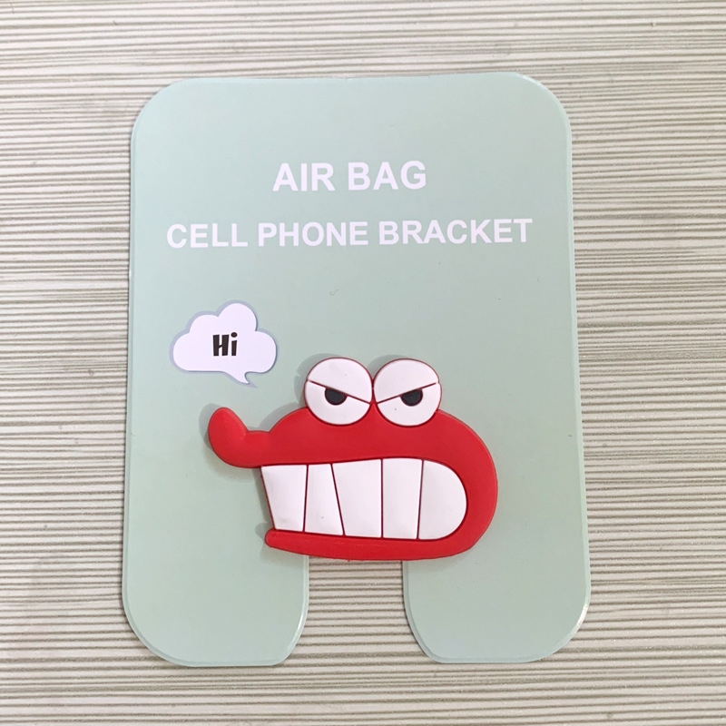 En stock al por mayor TikTok Cartoon creativo soporte de teléfono móvil puede soportar airbag soporte de teléfono móvil soporte de escritorio