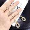 Long universal asymmetrical earrings from pearl with tassels, bright catchy style