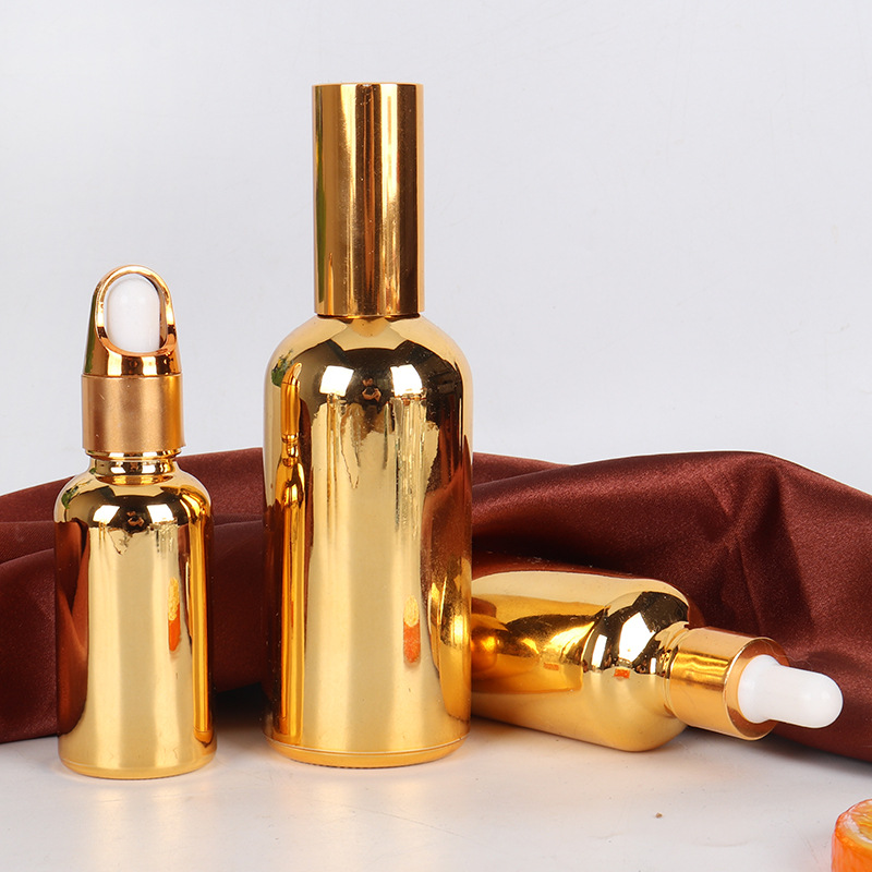 Venta al por mayor de aceite esencial chapado en oro sub-botella de vidrio botella cosmética 10-100ml de plástico cabeza gotero spray sellado botella vacía