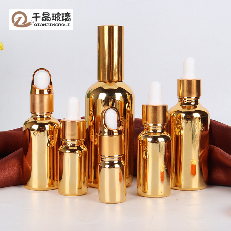 Venta al por mayor de aceite esencial chapado en oro sub-botella de vidrio botella cosmética 10-100ml de plástico cabeza gotero spray sellado botella vacía