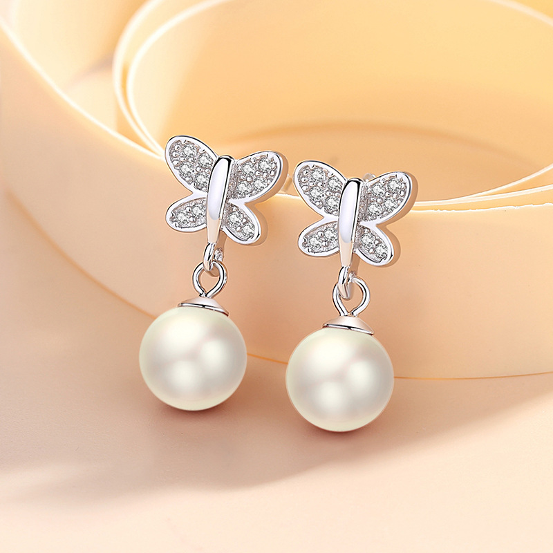 Shengli S925 Pendientes de mariposa de aguja de plata Pendientes de perlas rojas con microincrustaciones de circón Pendientes frescos pequeños japoneses y coreanos Mujeres al por mayor