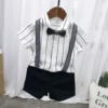 White shirt, trousers, bow tie, suspenders