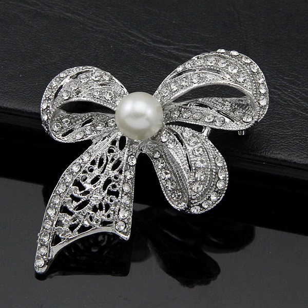 White brooch with bow lapel pin, bag accessory