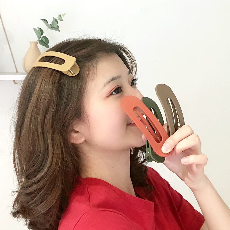 ヘアピンの女性の大きいサイズの顔を洗って、サイドを挟んで後頭部の髪の毛を挟みます。|undefined