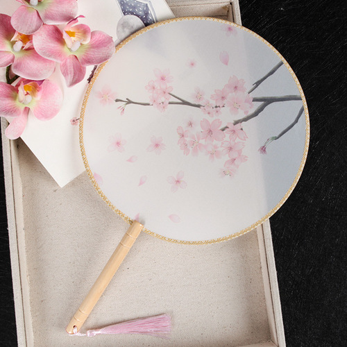An ancient-style wooden-handled half-transparent Hanfu round fan with Chinese architectural elements, featuring a wooden handle and silk gauze, suitable for photography.