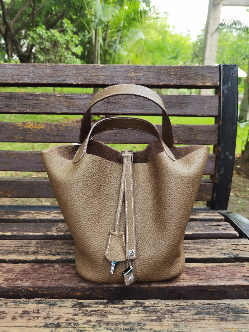 El nuevo bolso de cesta de verduras de marea de cuero togo de piel de vaca de capa superior 2025, bolso de cubo con cerradura de mano, bolso de cuero para mujer