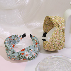 Korean floral hair clip with INS cross-knot design, simple wide edge hair clip, anti-slip, versatile hair accessory for outdoor use.