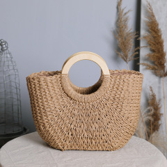 A vintage woven backpack with a large capacity, wood handle, grass weave, INS seaside vacation sandbag.