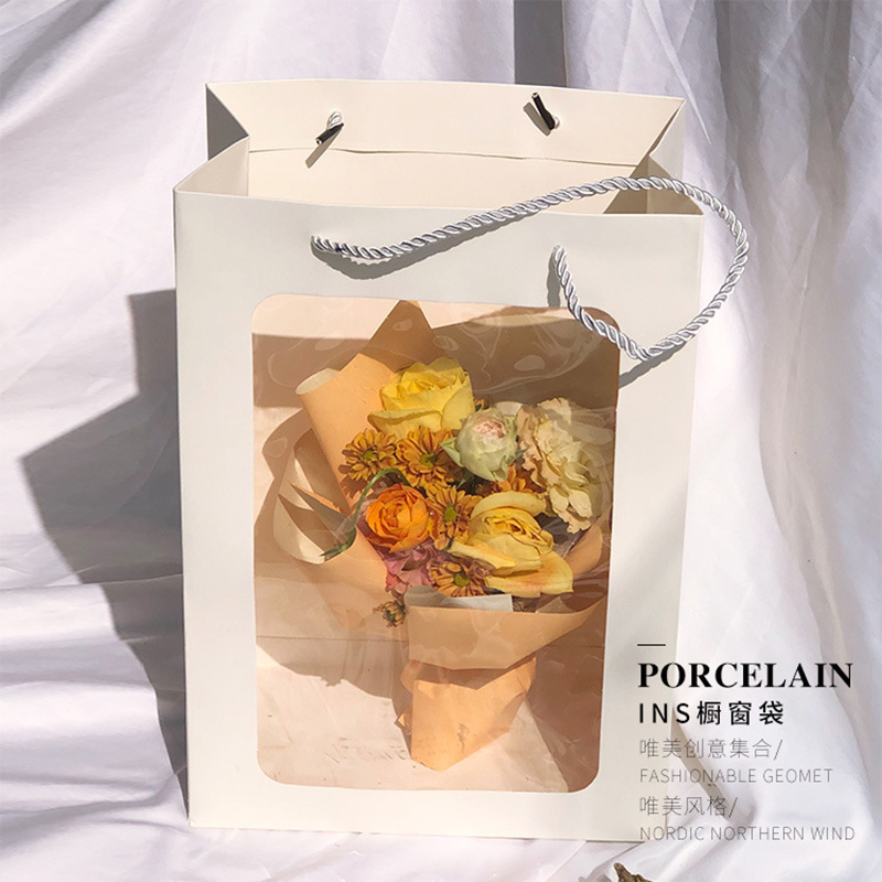 Venta al por mayor Liuyi INS Ventana Bolso de mano Embalaje de ramo Bolso de mano de flores Bolso de regalo de ventana Bolso de papel kraft