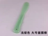 Green face mask, scraper