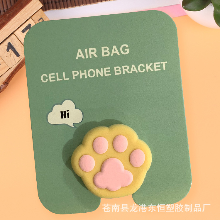 En stock al por mayor TikTok Cartoon creativo soporte de teléfono móvil puede soportar airbag soporte de teléfono móvil soporte de escritorio