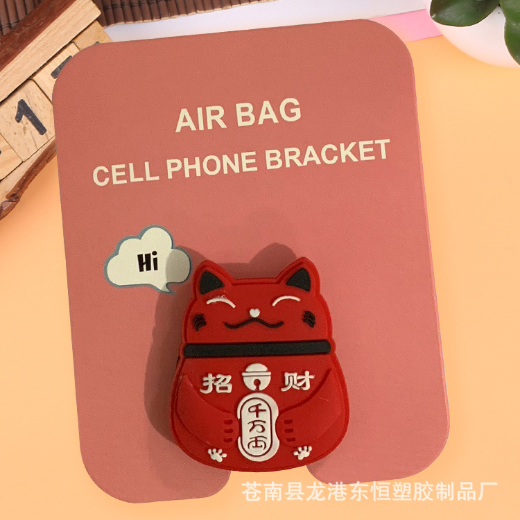 En stock al por mayor TikTok Cartoon creativo soporte de teléfono móvil puede soportar airbag soporte de teléfono móvil soporte de escritorio
