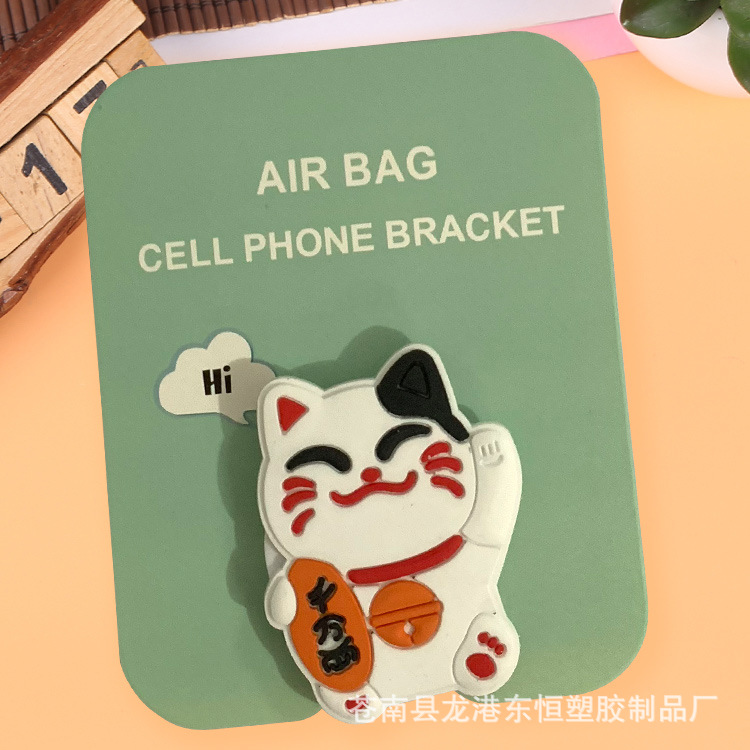 En stock al por mayor TikTok Cartoon creativo soporte de teléfono móvil puede soportar airbag soporte de teléfono móvil soporte de escritorio