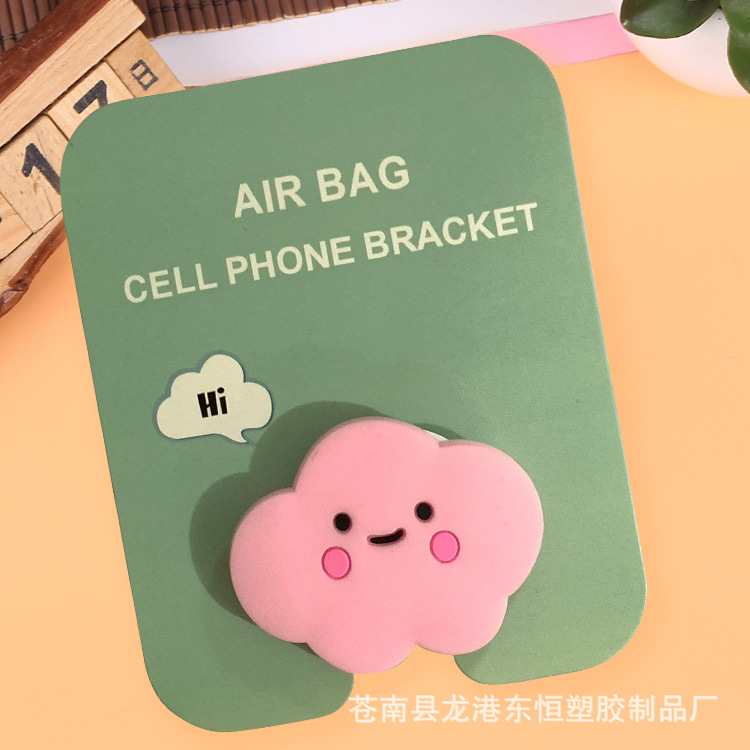 En stock al por mayor TikTok Cartoon creativo soporte de teléfono móvil puede soportar airbag soporte de teléfono móvil soporte de escritorio