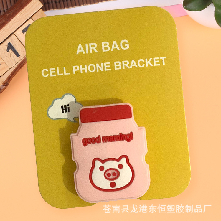 En stock al por mayor TikTok Cartoon creativo soporte de teléfono móvil puede soportar airbag soporte de teléfono móvil soporte de escritorio